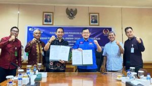 H. Hendri Zainuddin, Ketua KONI Sumsel (baju biru), melakukan penandatanganan MoU dengan Kakanwil BPJS Ketenagakerjaan Sumbagsel, Eko Purnomo, tentang perlindungan bagi atlet. (foto : Oyong Hairudin)