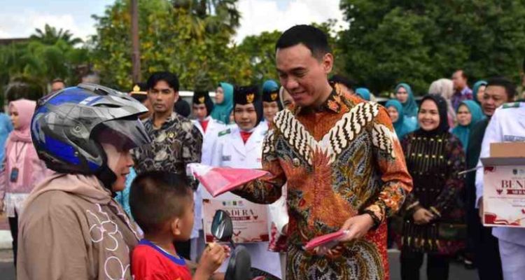 H. Muchendi Mahzareki pada kegiatan Gerakan Pembagian Bendera Merah Putih yang berlangsung di Lapangan Segitiga Emas Kayuagung, Jumat (1/8).
